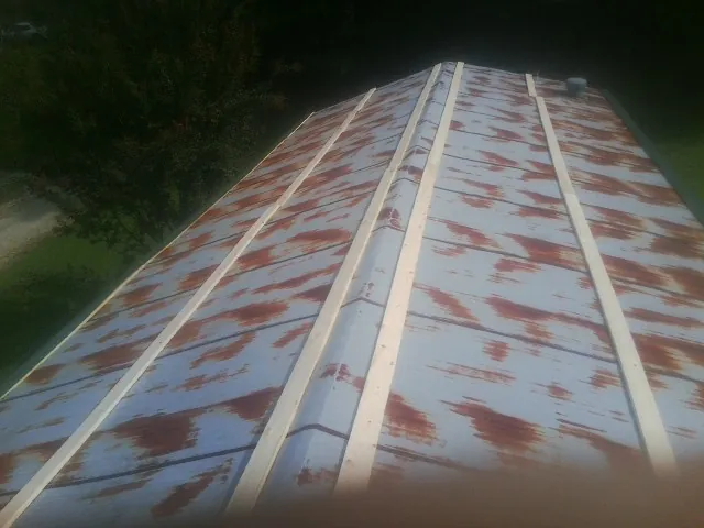 Rusted metal roof panels with new wood purlins before replacement — Storm Damage Roof Repair in Tippecanoe by Roofing Brothers