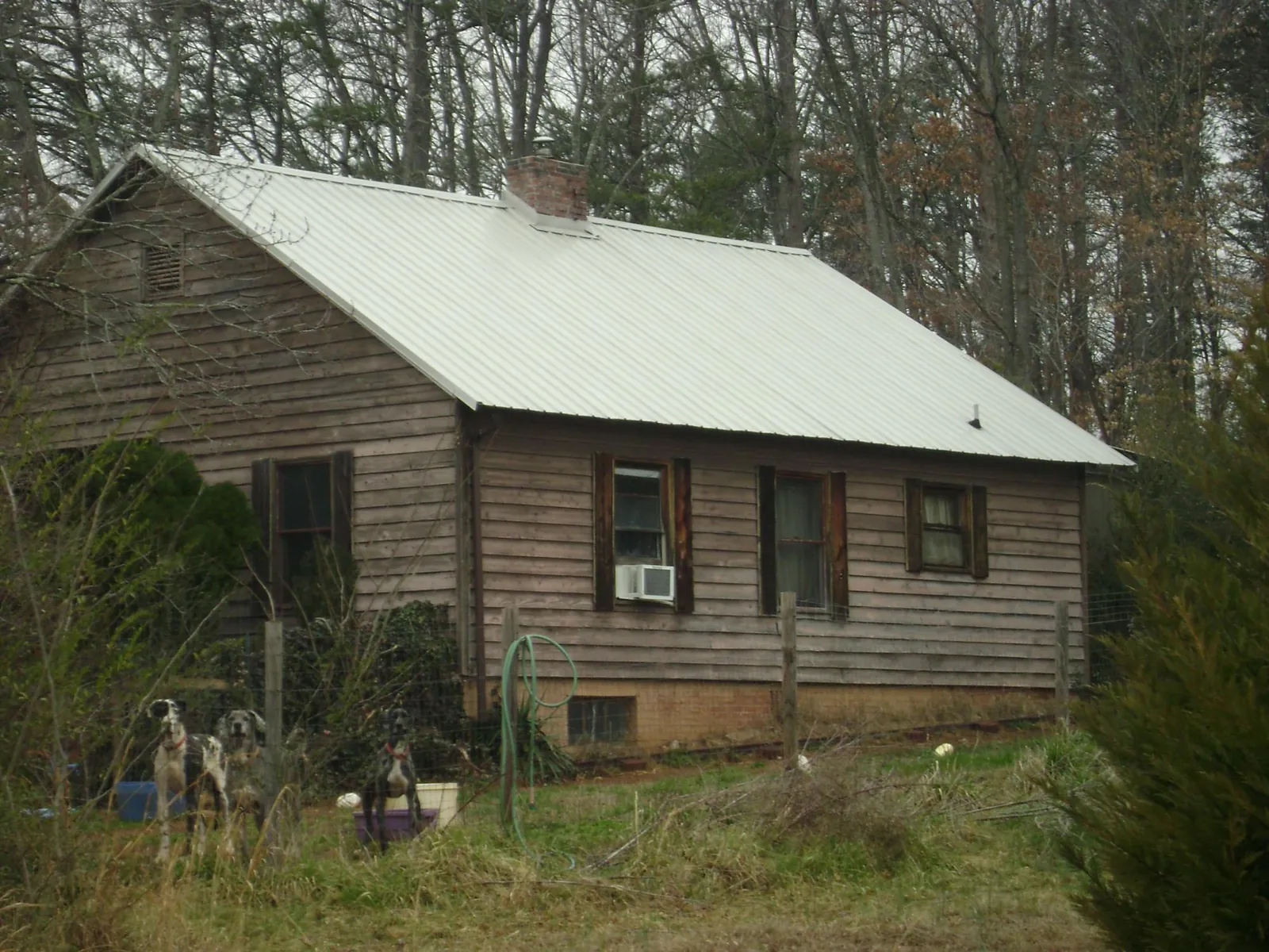 White metal roof on an old wood sided farmhouse, from a Metal Roof Installation job in Tippecanoe